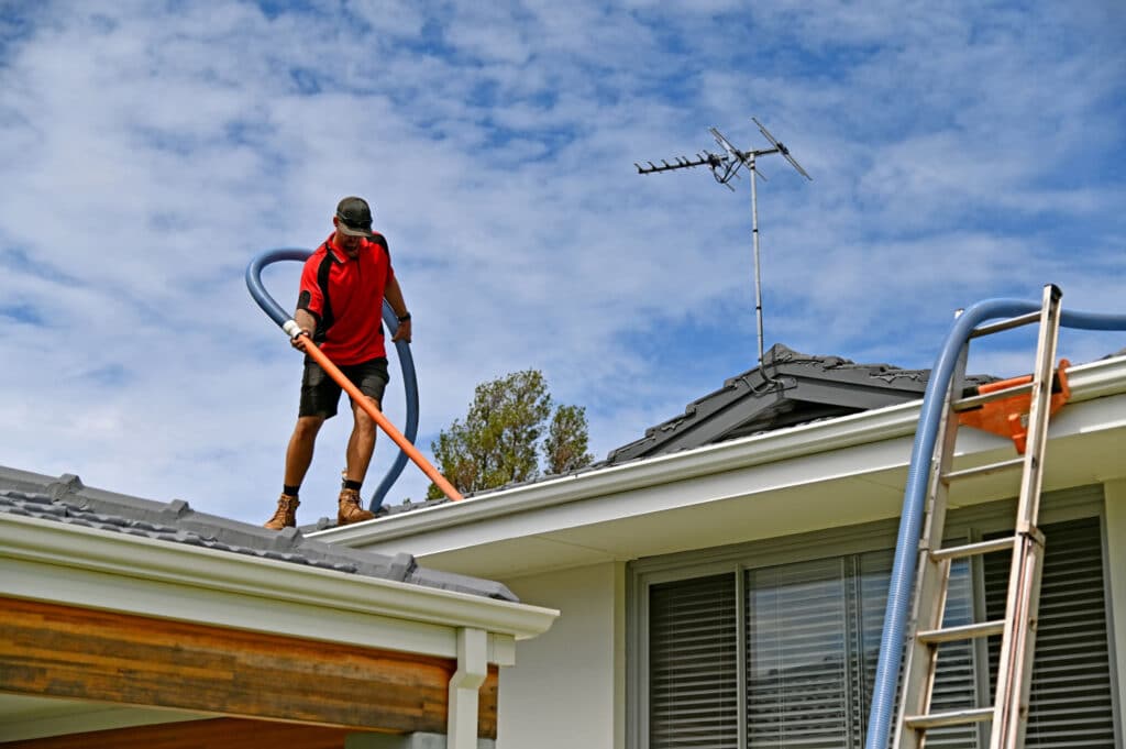 Gutter Surgeon cleaning gutters on a home in Chipley Florida